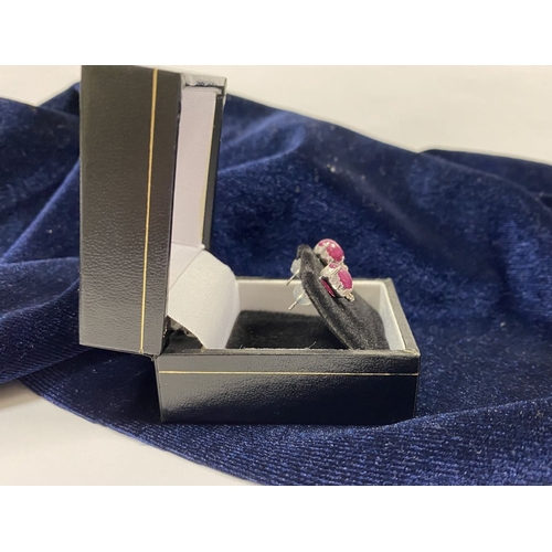 16 - A PAIR OF 18CT WHITE GOLD RUBY & DIAMOND STUD EARRINGS, with oval cut rubies in four prong claw sett... 