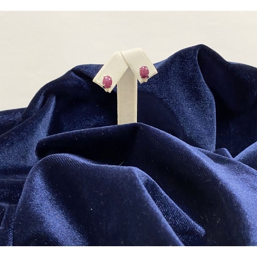 16 - A PAIR OF 18CT WHITE GOLD RUBY & DIAMOND STUD EARRINGS, with oval cut rubies in four prong claw sett... 