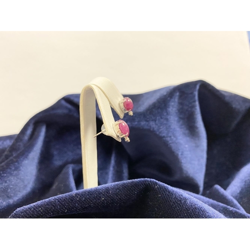 16 - A PAIR OF 18CT WHITE GOLD RUBY & DIAMOND STUD EARRINGS, with oval cut rubies in four prong claw sett... 