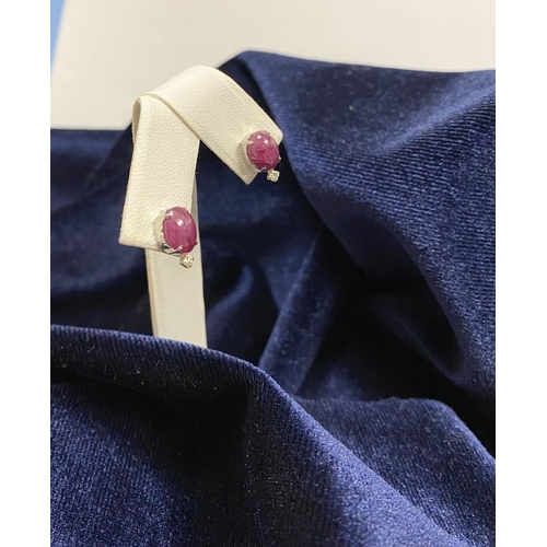 16 - A PAIR OF 18CT WHITE GOLD RUBY & DIAMOND STUD EARRINGS, with oval cut rubies in four prong claw sett... 