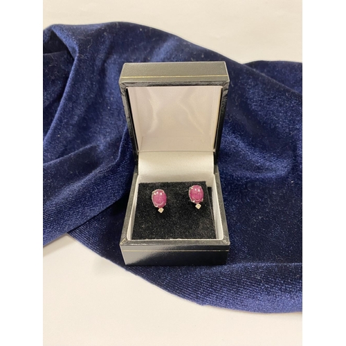 16 - A PAIR OF 18CT WHITE GOLD RUBY & DIAMOND STUD EARRINGS, with oval cut rubies in four prong claw sett... 