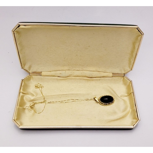 46 - AN ATTRACTIVE 14CT YELLOW GOLD GARNET PENDANT NECKLACE, lovely delicate link chain holds the oval sh... 