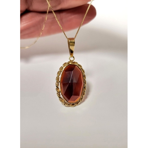 46 - AN ATTRACTIVE 14CT YELLOW GOLD GARNET PENDANT NECKLACE, lovely delicate link chain holds the oval sh... 