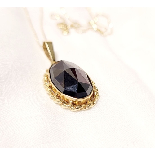 46 - AN ATTRACTIVE 14CT YELLOW GOLD GARNET PENDANT NECKLACE, lovely delicate link chain holds the oval sh... 