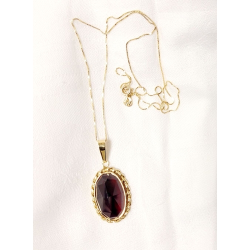 46 - AN ATTRACTIVE 14CT YELLOW GOLD GARNET PENDANT NECKLACE, lovely delicate link chain holds the oval sh... 
