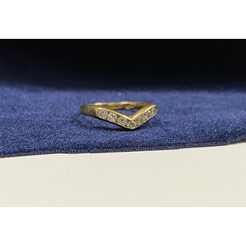50 - A DAINTY 9CT YELLOW GOLD CUBIC ZIRCONIA WISHBONE RING, with seven round cut cubic zirconia channel s... 