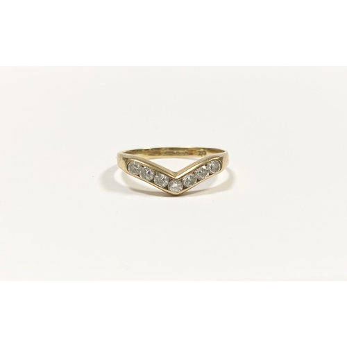 50 - A DAINTY 9CT YELLOW GOLD CUBIC ZIRCONIA WISHBONE RING, with seven round cut cubic zirconia channel s... 