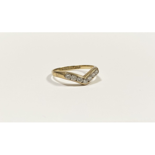 50 - A DAINTY 9CT YELLOW GOLD CUBIC ZIRCONIA WISHBONE RING, with seven round cut cubic zirconia channel s... 