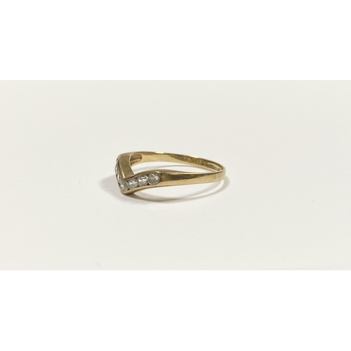 50 - A DAINTY 9CT YELLOW GOLD CUBIC ZIRCONIA WISHBONE RING, with seven round cut cubic zirconia channel s... 