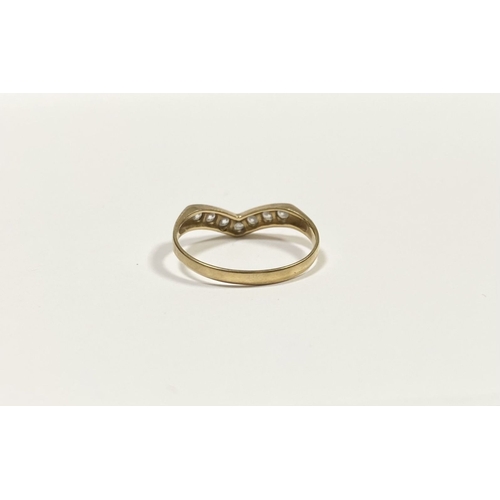50 - A DAINTY 9CT YELLOW GOLD CUBIC ZIRCONIA WISHBONE RING, with seven round cut cubic zirconia channel s... 