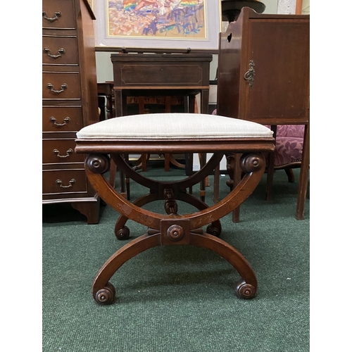 66 - A 19TH CENTURY MAHOGANY AND UPHOLSTERED STOOL the square upholstered seat on X-shaped supports with ... 