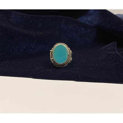 72 - A STERLING SILVER & TURQUOISE ‘LOCKET/POISON’ RING, featuring oval cut turquoise bezel set in raised... 