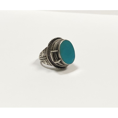 72 - A STERLING SILVER & TURQUOISE ‘LOCKET/POISON’ RING, featuring oval cut turquoise bezel set in raised... 