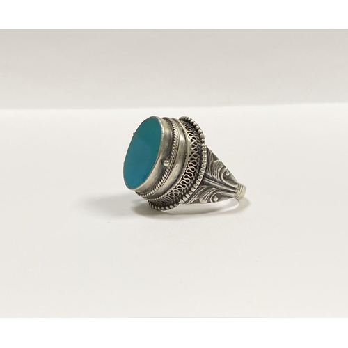 72 - A STERLING SILVER & TURQUOISE ‘LOCKET/POISON’ RING, featuring oval cut turquoise bezel set in raised... 