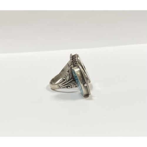 72 - A STERLING SILVER & TURQUOISE ‘LOCKET/POISON’ RING, featuring oval cut turquoise bezel set in raised... 