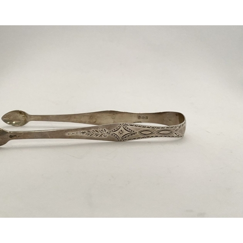 73 - A FINE GEORGE III SILVER SUGAR TONGS, with intricate bright cut engraving featuring diamond and blan... 