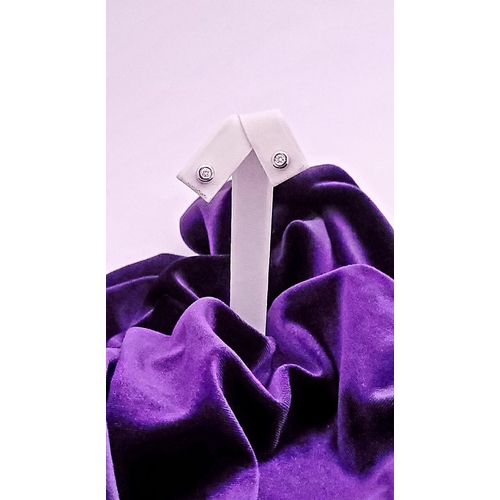 74 - A PAIR OF DIAMOND STUD EARRINGS each in a roll-over cylindrical column setting, with ALPA secure bac... 