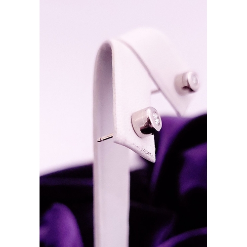 74 - A PAIR OF DIAMOND STUD EARRINGS each in a roll-over cylindrical column setting, with ALPA secure bac... 