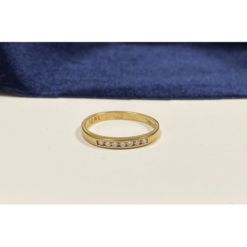 80 - A BEAUTIFUL 9CT YELLOW GOLD SEVEN STONE DIAMOND RING, the seven round cut diamonds are channel set w... 