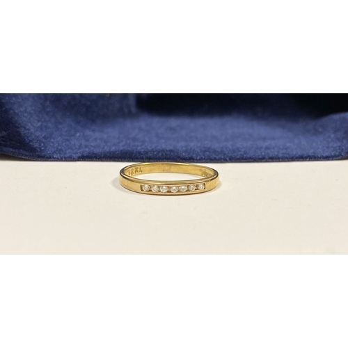 80 - A BEAUTIFUL 9CT YELLOW GOLD SEVEN STONE DIAMOND RING, the seven round cut diamonds are channel set w... 