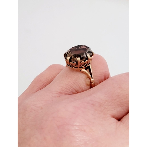 82 - A FANTASTIC VINTAGE 9CT YELLOW GOLD SMOKEY QUARTZ RING, the large oval shaped quartz is set within a... 