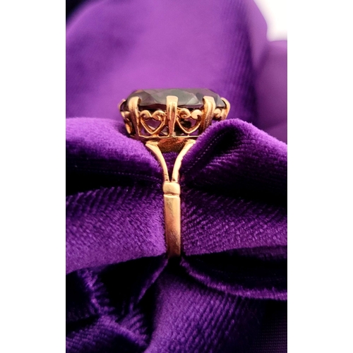 82 - A FANTASTIC VINTAGE 9CT YELLOW GOLD SMOKEY QUARTZ RING, the large oval shaped quartz is set within a... 