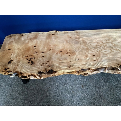 85 - A WALNUT RECLAIMED WOOD COFFEE TABLE, raised on metal base with supports to either side, dimensions:... 