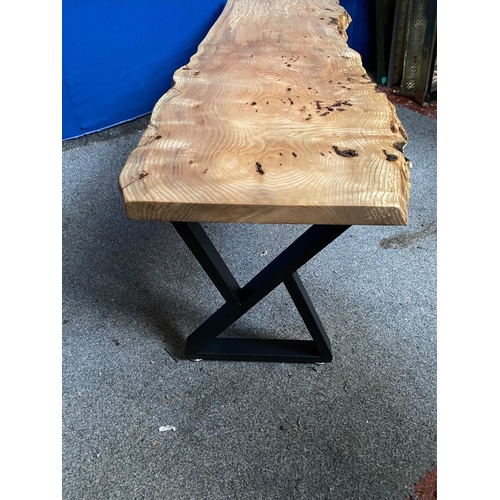 85 - A WALNUT RECLAIMED WOOD COFFEE TABLE, raised on metal base with supports to either side, dimensions:... 