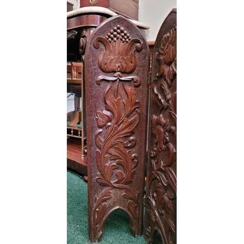 88 - A BEAUTIFUL HAND CARVED FOLDING WOODEN SCREEN, the front of each of the three panels decorated with ... 