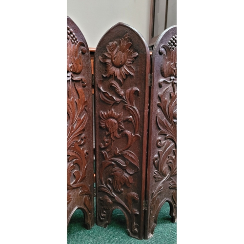88 - A BEAUTIFUL HAND CARVED FOLDING WOODEN SCREEN, the front of each of the three panels decorated with ... 