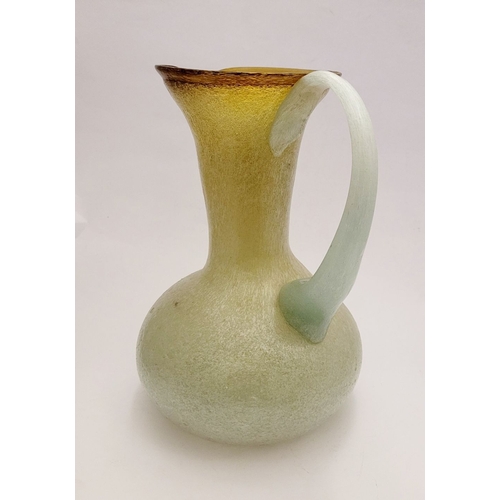 96 - A VINTAGE EARLY 20TH CENTURY ‘STRETCH-GLASS’ PITCHER, the beautifully formed glass pitcher has a cur... 