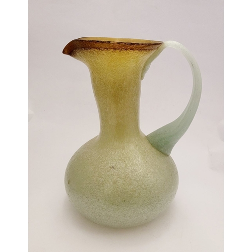 96 - A VINTAGE EARLY 20TH CENTURY ‘STRETCH-GLASS’ PITCHER, the beautifully formed glass pitcher has a cur... 