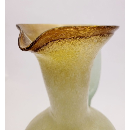 96 - A VINTAGE EARLY 20TH CENTURY ‘STRETCH-GLASS’ PITCHER, the beautifully formed glass pitcher has a cur... 
