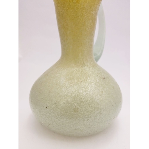96 - A VINTAGE EARLY 20TH CENTURY ‘STRETCH-GLASS’ PITCHER, the beautifully formed glass pitcher has a cur... 