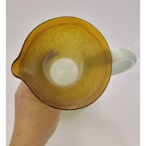 96 - A VINTAGE EARLY 20TH CENTURY ‘STRETCH-GLASS’ PITCHER, the beautifully formed glass pitcher has a cur... 