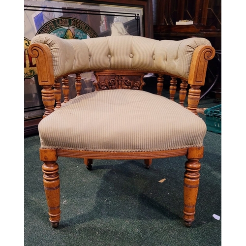 104 - A LATE 19TH CENTURY OAK CAPTAINS CHAIR, with curved padded & buttoned back/armrest raised on ring tu... 