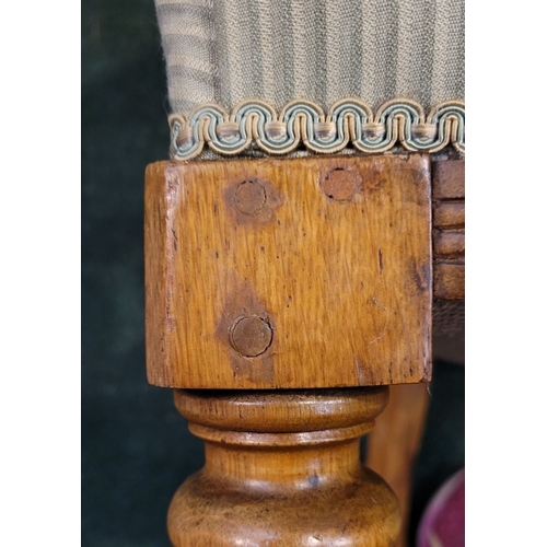 104 - A LATE 19TH CENTURY OAK CAPTAINS CHAIR, with curved padded & buttoned back/armrest raised on ring tu... 