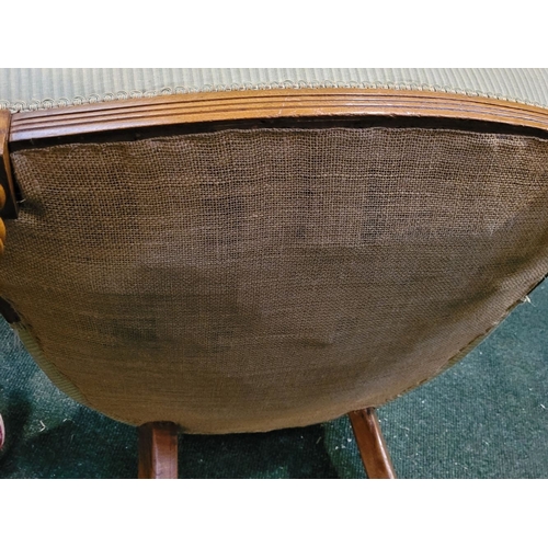 104 - A LATE 19TH CENTURY OAK CAPTAINS CHAIR, with curved padded & buttoned back/armrest raised on ring tu... 