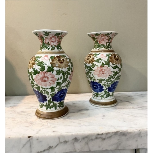 105 - A DECORATIVE PAIR OF FLORAL PAINTED VASES, baluster form with flared rim, painted with floral design... 