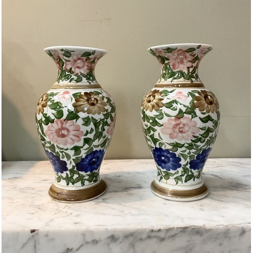 105 - A DECORATIVE PAIR OF FLORAL PAINTED VASES, baluster form with flared rim, painted with floral design... 