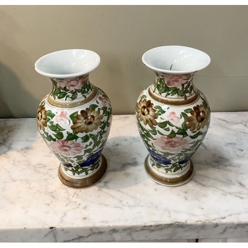 105 - A DECORATIVE PAIR OF FLORAL PAINTED VASES, baluster form with flared rim, painted with floral design... 