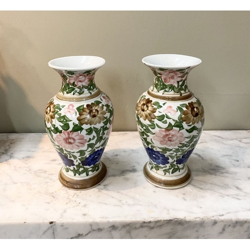 105 - A DECORATIVE PAIR OF FLORAL PAINTED VASES, baluster form with flared rim, painted with floral design... 