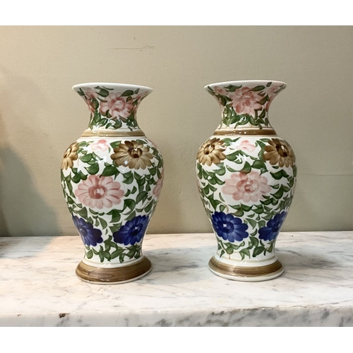 105 - A DECORATIVE PAIR OF FLORAL PAINTED VASES, baluster form with flared rim, painted with floral design... 