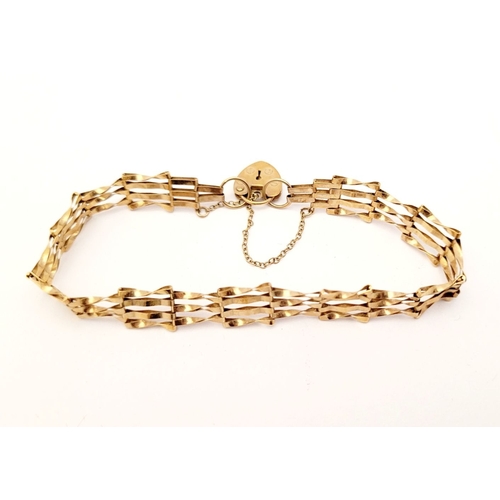 109 - A DELICATE 9CT GOLD GATE LINK BRACELET, with heart shaped lock clasp with security chain attached. L... 