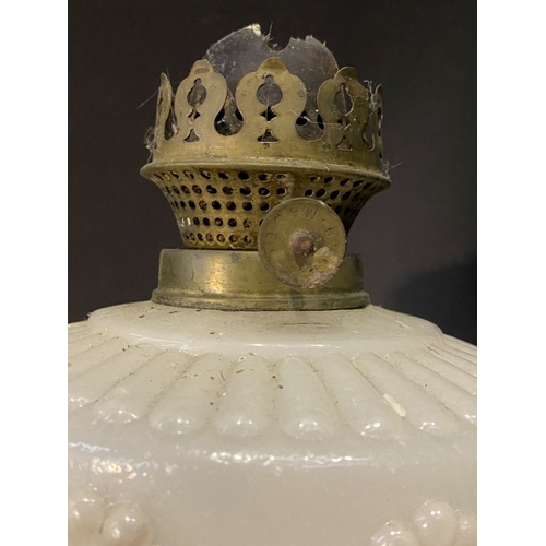 119 - AN ANTIQUE MILK GLASS OIL LAMP, the font with moulded flowers surrounding, on Column base on circula... 