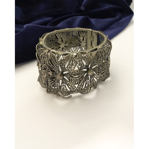 122 - A VINTAGE LARGE BARTEK FILIGREE BANGLE BRACELET, beautiful intricate floral design surrounding in si... 