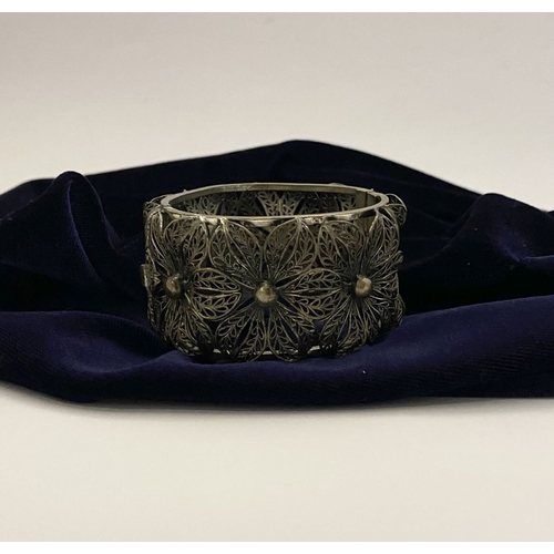 122 - A VINTAGE LARGE BARTEK FILIGREE BANGLE BRACELET, beautiful intricate floral design surrounding in si... 