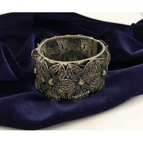 122 - A VINTAGE LARGE BARTEK FILIGREE BANGLE BRACELET, beautiful intricate floral design surrounding in si... 