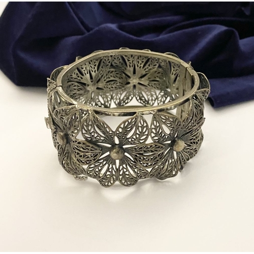 122 - A VINTAGE LARGE BARTEK FILIGREE BANGLE BRACELET, beautiful intricate floral design surrounding in si... 