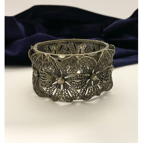 122 - A VINTAGE LARGE BARTEK FILIGREE BANGLE BRACELET, beautiful intricate floral design surrounding in si... 